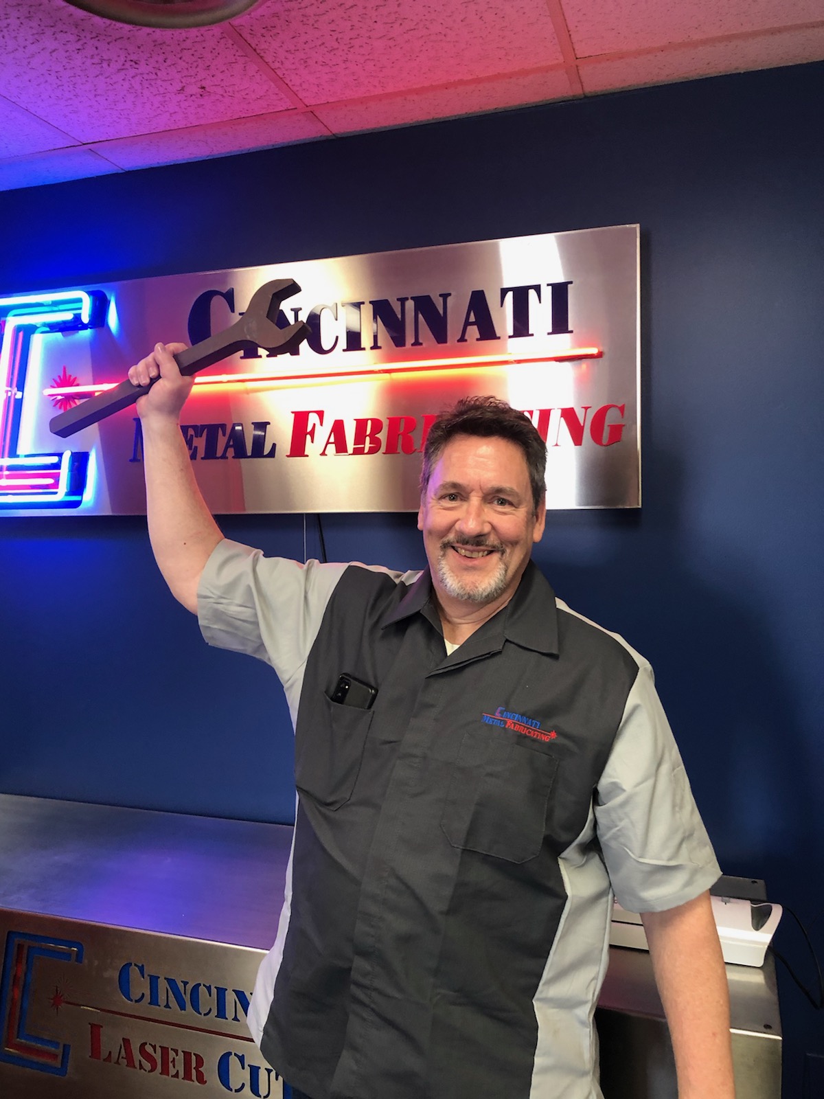 Cincinnati Metal Fabricating team member with custom wrench