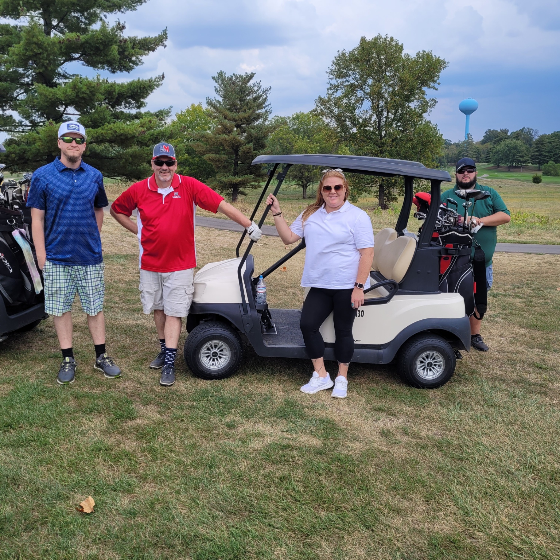 CMF team at golf outing with cart