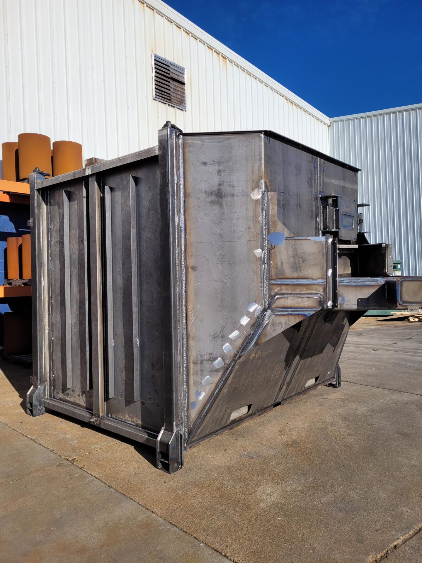 Large welded steel hopper outside facility