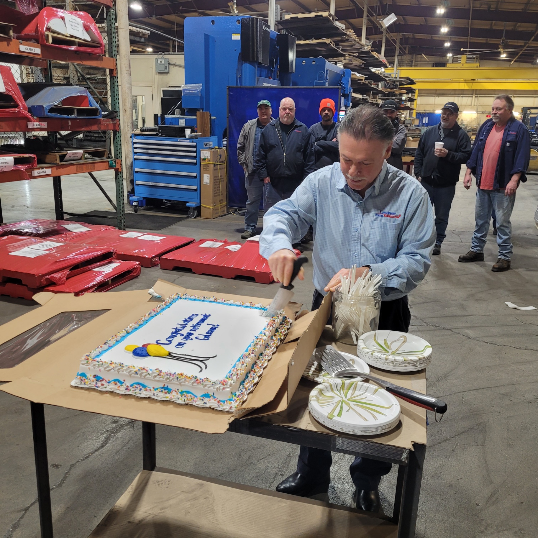Team celebrating a retirement milestone on the shop floor