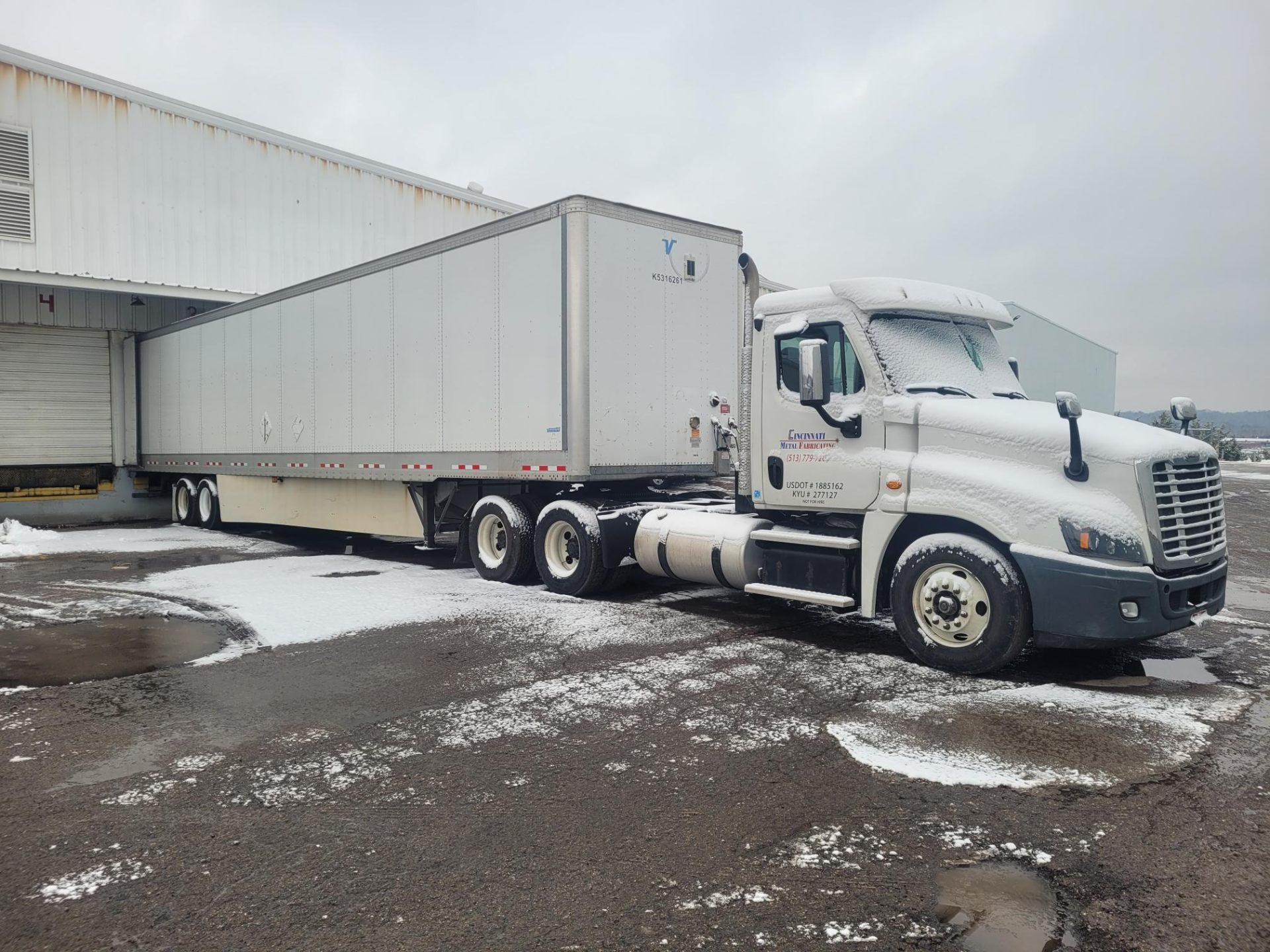 CMF semi truck and trailer at loading dock