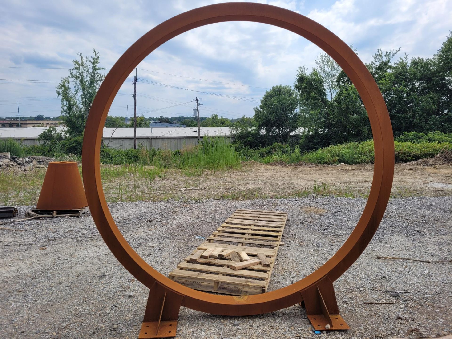 Large corten steel ring sculpture outdoors