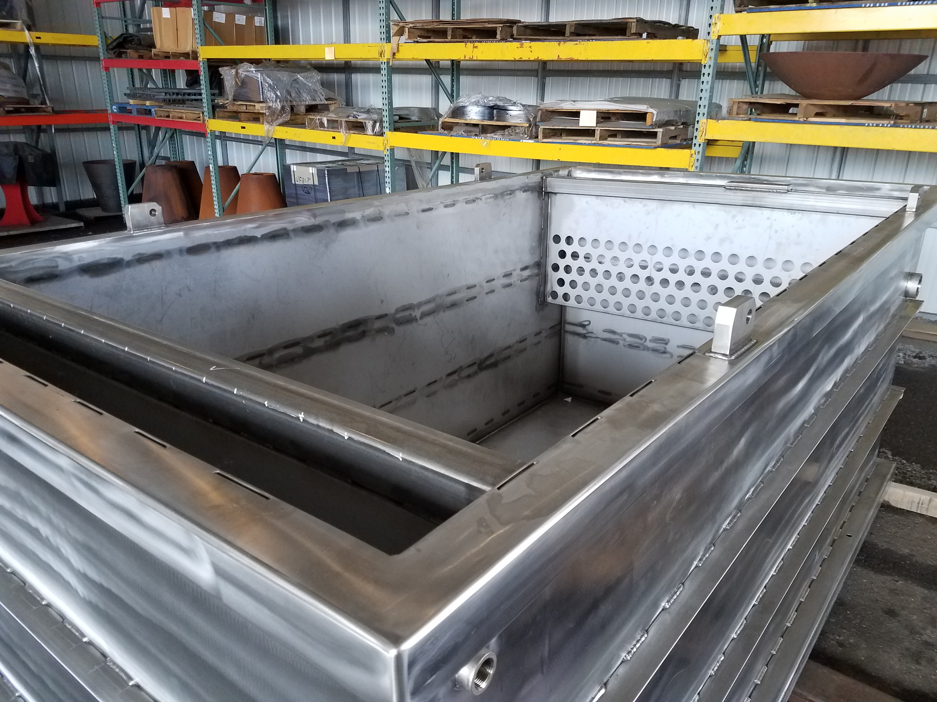 Large stainless steel tank with perforated panels