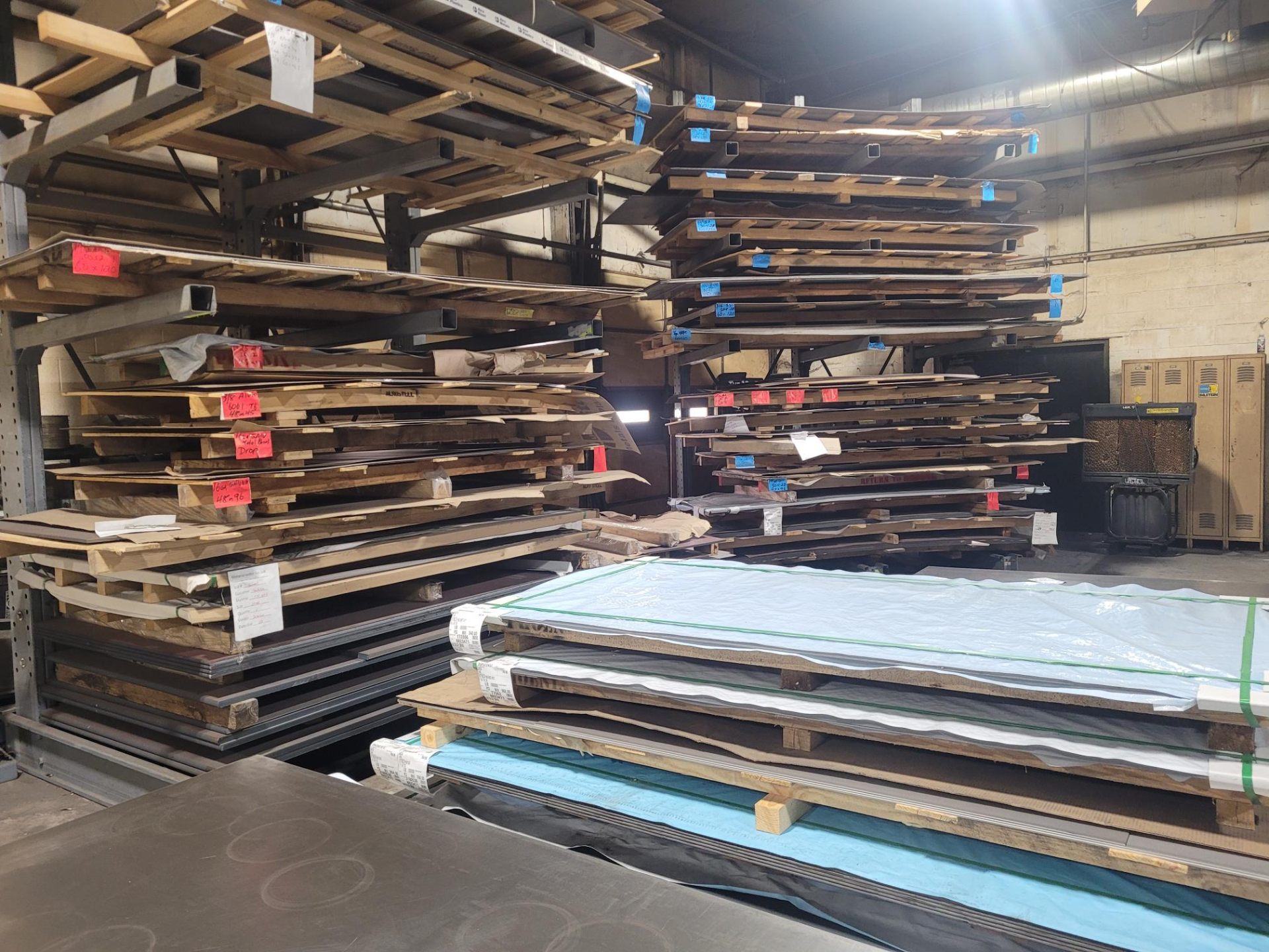 Multiple racks of raw materials with labels