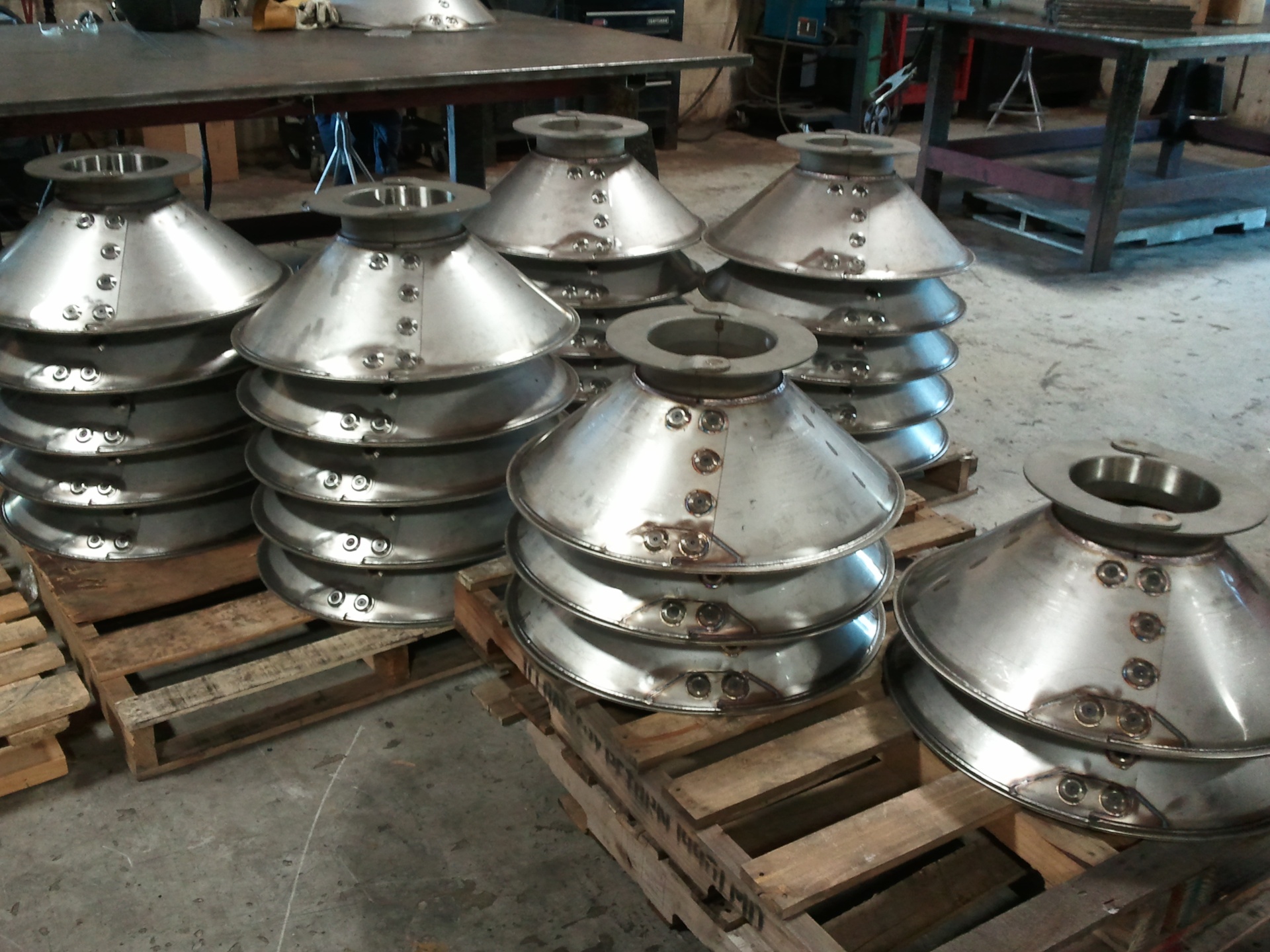 Stainless steel conical baskets stacked on pallets