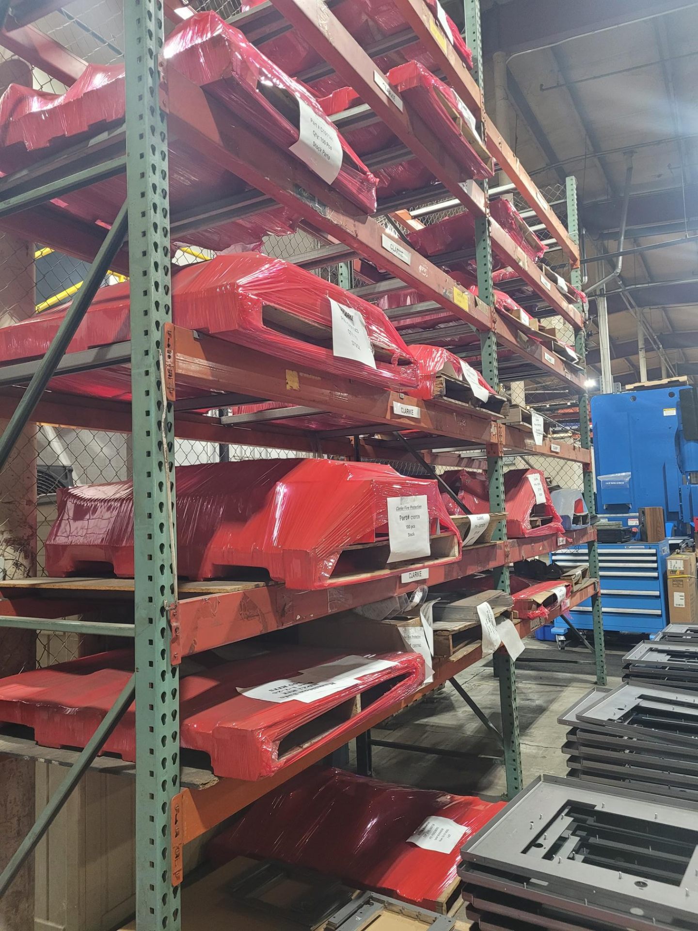 Warehouse racking with labeled red parts ready for stocking program